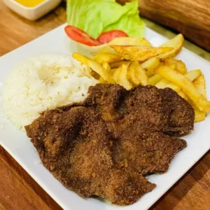 Breaded steak served with french fries & tomatoes