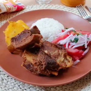 Tender strips of beef are expertly fried to perfection and served with a generous accompaniment of rice, crispy potato fries, onions, zesty lemon wedges, fresh tomatoes, and crisp salad.