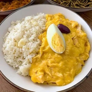 Shredded chicken cooked in a creamy and yellow spicy sauce serveced on top of boiled half potatoes.